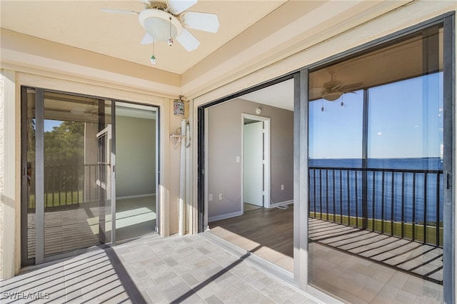 interior space featuring a water view and ceiling fan