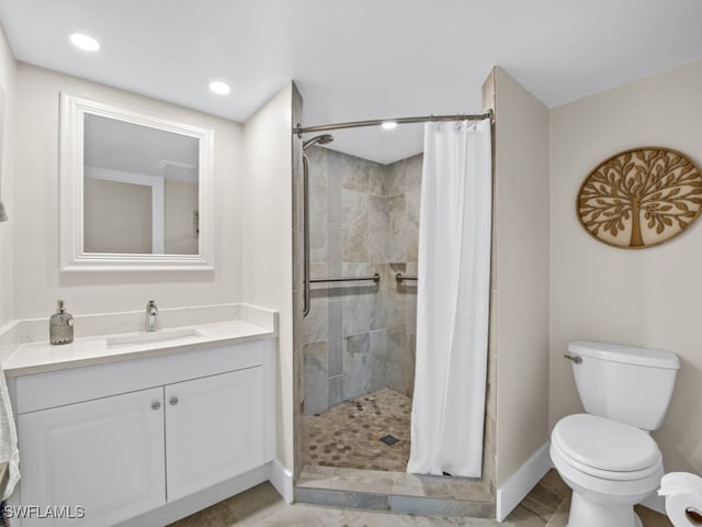 bathroom with vanity, toilet, and walk in shower