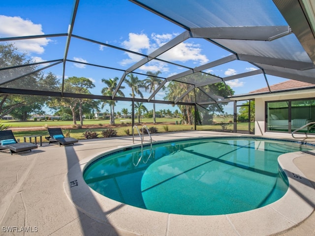 view of pool with a lanai and a patio