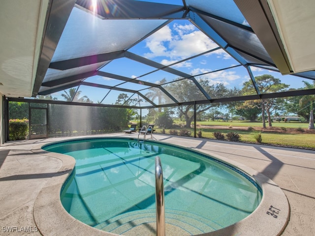 view of pool featuring a patio and glass enclosure