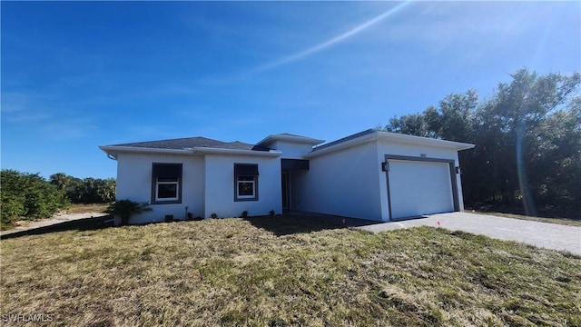 view of front of house with a front yard and a garage