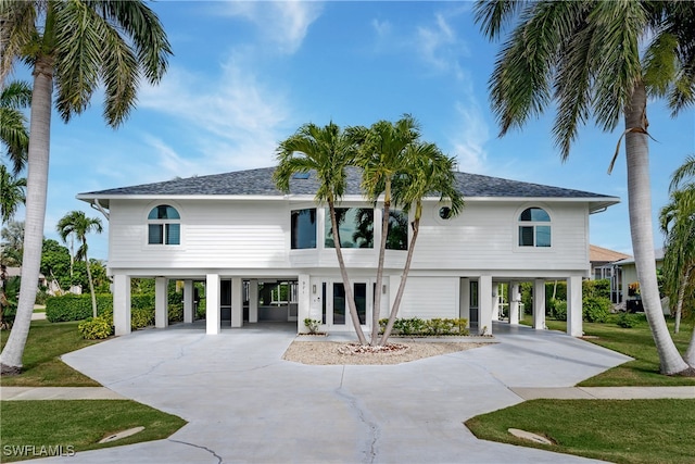 rear view of property featuring a yard and a carport