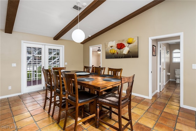 dining room featuring french doors, lofted ceiling with beams, light tile patterned floors, and a wealth of natural light