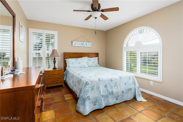 bedroom featuring tile patterned flooring, multiple windows, and ceiling fan