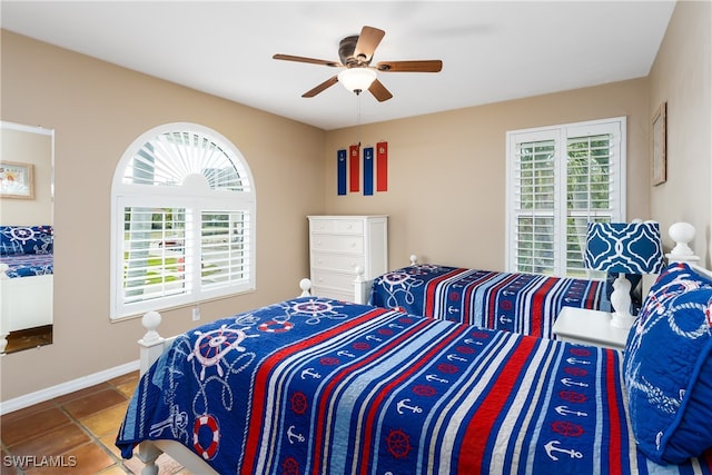 tiled bedroom featuring ceiling fan