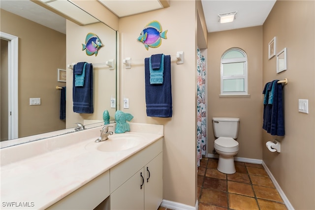 bathroom featuring tile patterned floors, vanity, and toilet