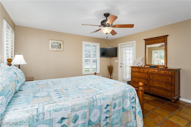 bedroom with ceiling fan and dark tile patterned flooring