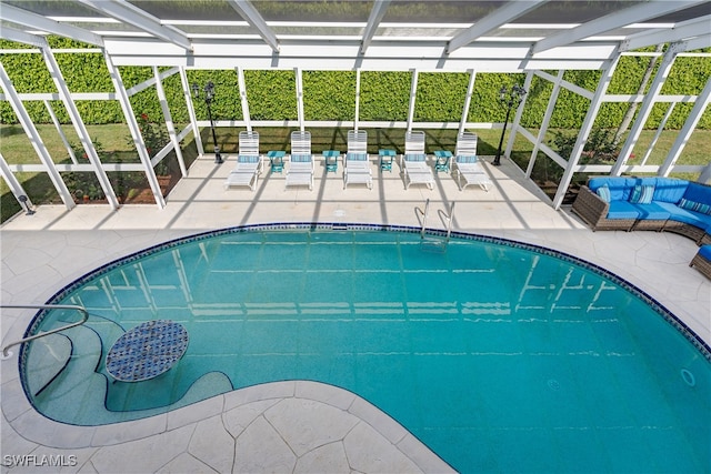 view of swimming pool featuring a patio and glass enclosure