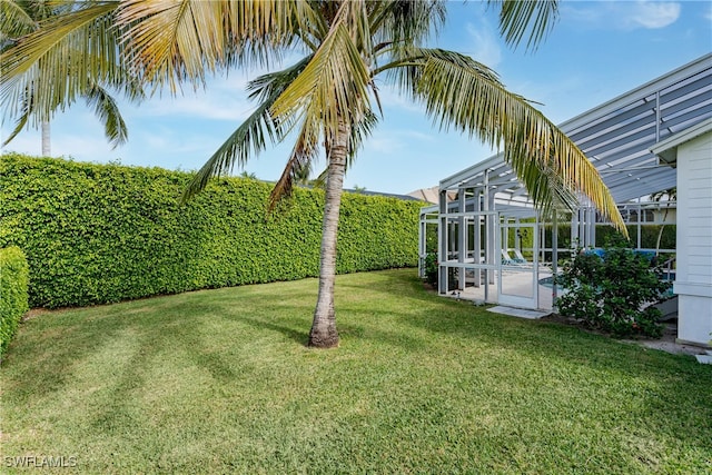 view of yard with a lanai