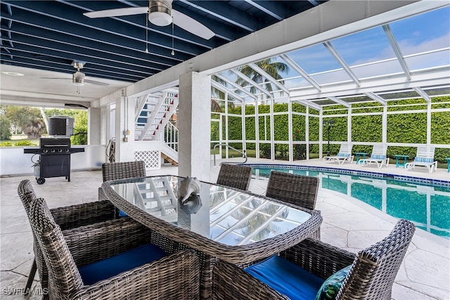 view of pool featuring ceiling fan, a grill, a lanai, and a patio