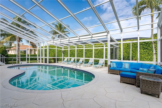 view of swimming pool with glass enclosure, a patio area, and an outdoor hangout area