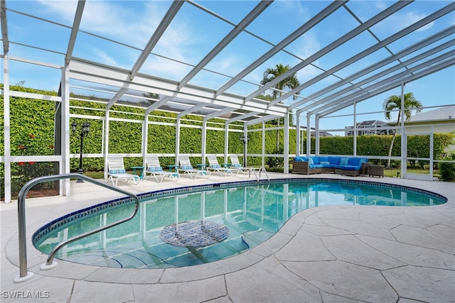 view of swimming pool with outdoor lounge area, a patio area, and a lanai