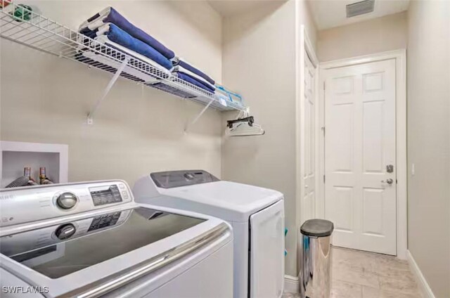 washroom with independent washer and dryer