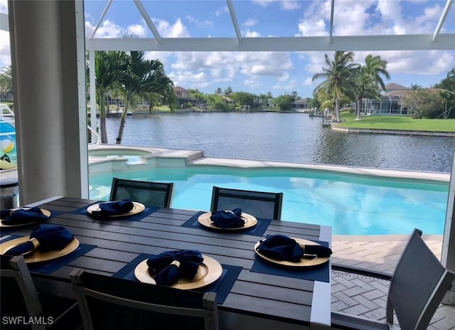 view of pool with a lanai, an in ground hot tub, and a patio