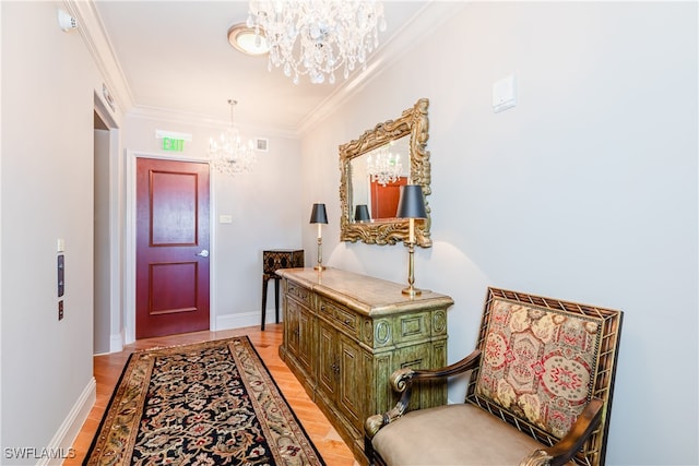 interior space with a chandelier, light hardwood / wood-style floors, and crown molding