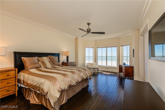 bedroom featuring dark wood-type flooring, ceiling fan, crown molding, and a water view