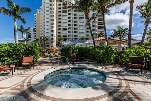 view of swimming pool with a patio and a hot tub