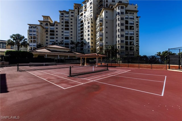 view of tennis court with basketball hoop