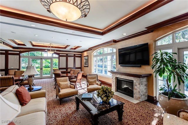 living room featuring ornamental molding, french doors, and a tray ceiling