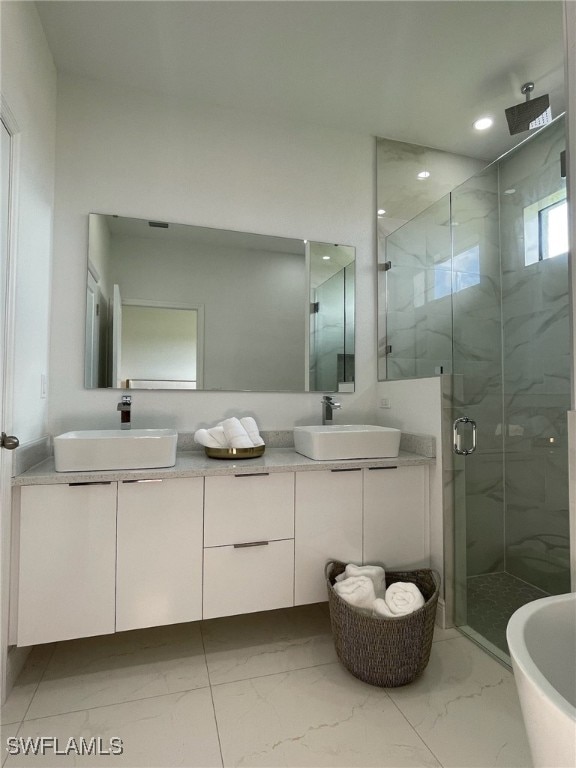 bathroom featuring vanity and a shower with door