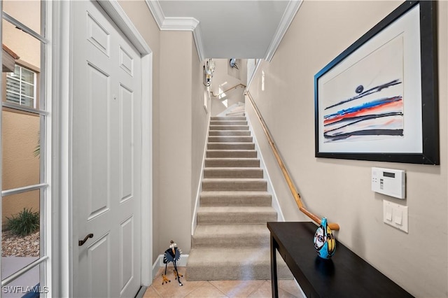 stairway featuring tile patterned flooring and crown molding