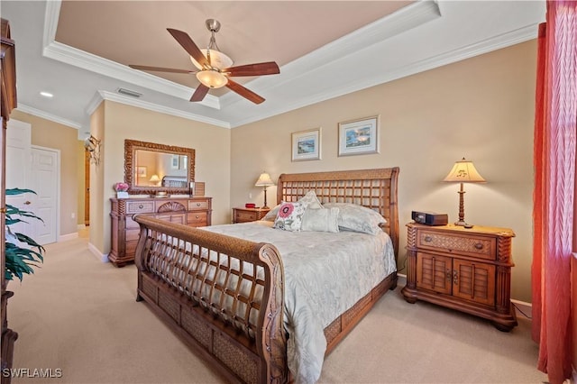 carpeted bedroom featuring ceiling fan, crown molding, and a tray ceiling