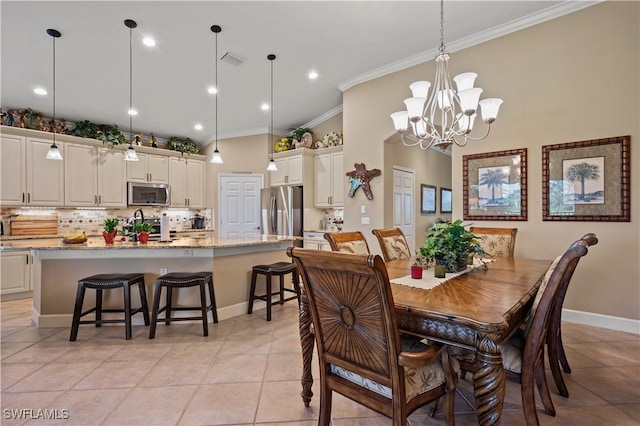 dining space with an inviting chandelier, ornamental molding, and light tile patterned flooring