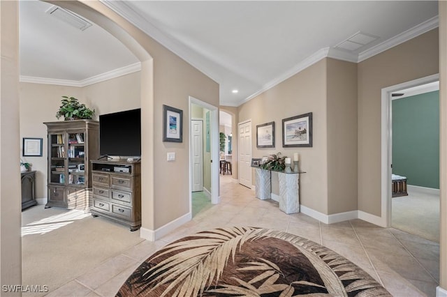 hallway with light tile patterned floors and crown molding