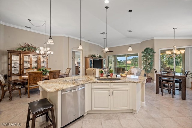 kitchen featuring dishwasher, light stone countertops, a center island, and decorative light fixtures