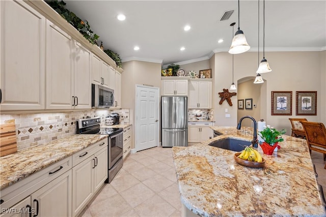 kitchen with appliances with stainless steel finishes, a center island with sink, and sink