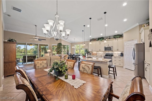 dining room with light tile patterned floors, ceiling fan with notable chandelier, vaulted ceiling, and ornamental molding