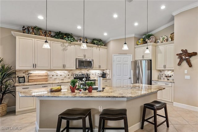 kitchen featuring a kitchen breakfast bar, stainless steel appliances, a kitchen island with sink, sink, and hanging light fixtures