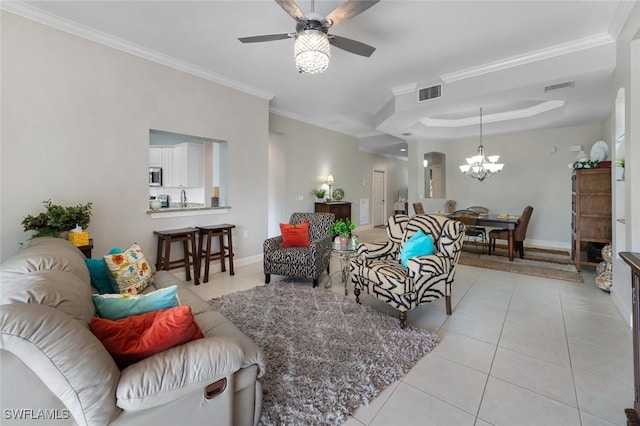 living room with ceiling fan with notable chandelier, ornamental molding, and light tile patterned floors