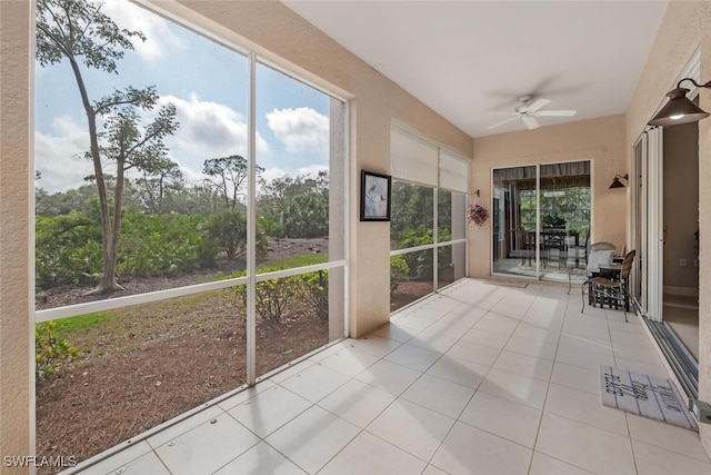 unfurnished sunroom with ceiling fan