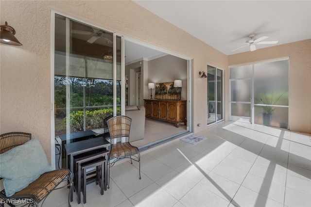 sunroom featuring ceiling fan