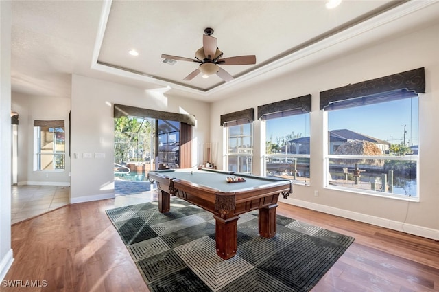 game room with wood-type flooring, billiards, a raised ceiling, and ceiling fan