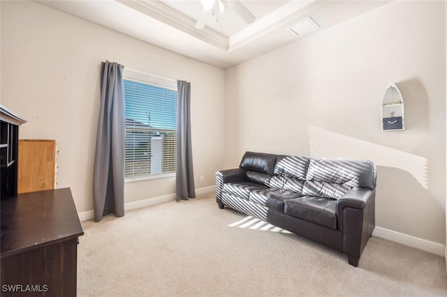 carpeted living room featuring crown molding, ceiling fan, and a tray ceiling