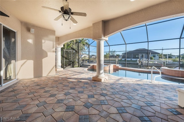 view of patio / terrace with an in ground hot tub, ceiling fan, and a lanai