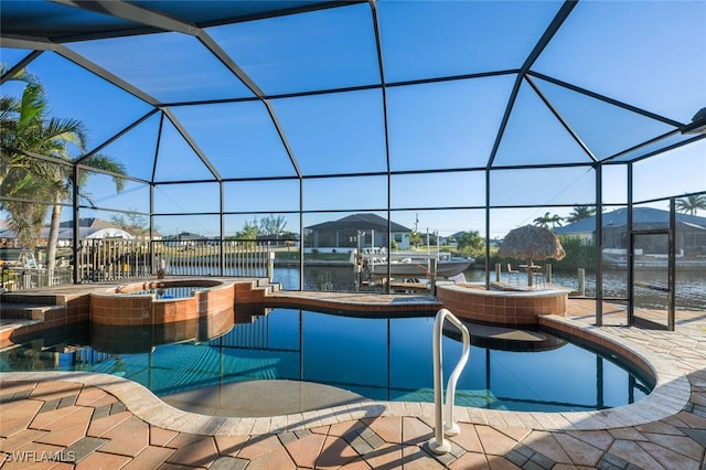 view of pool featuring an in ground hot tub, a patio, glass enclosure, and a water view