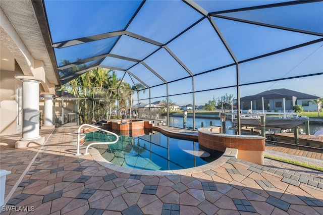 view of pool featuring an in ground hot tub, a water view, glass enclosure, and a patio