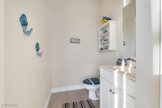 bathroom with tile patterned floors, toilet, and vanity