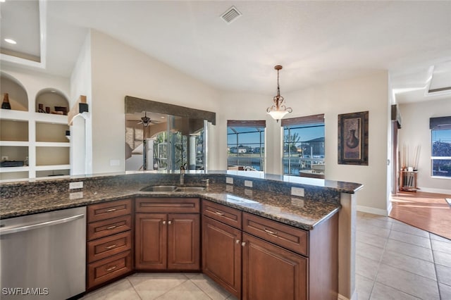 kitchen with sink, hanging light fixtures, light tile patterned floors, dishwasher, and built in features