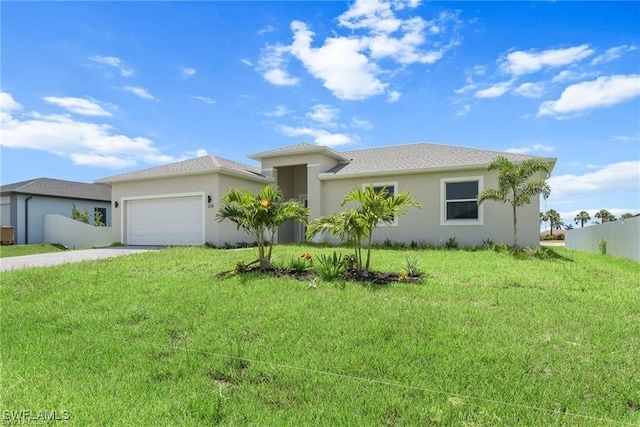 view of front of home featuring a front yard and a garage