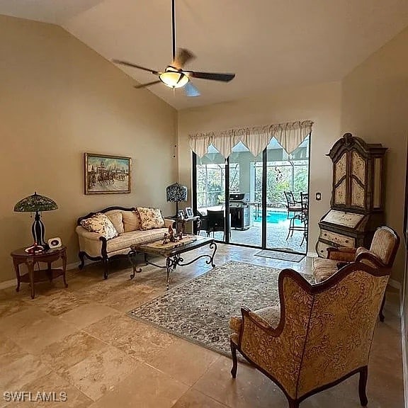 living room with ceiling fan and lofted ceiling