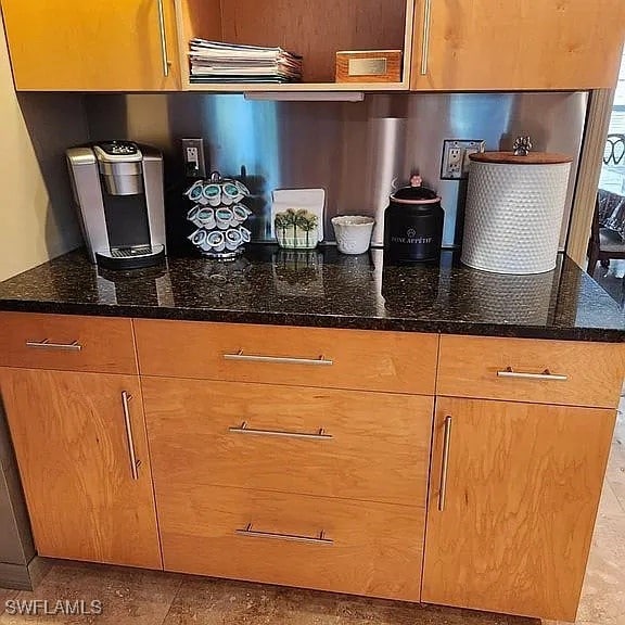 kitchen with dark stone countertops