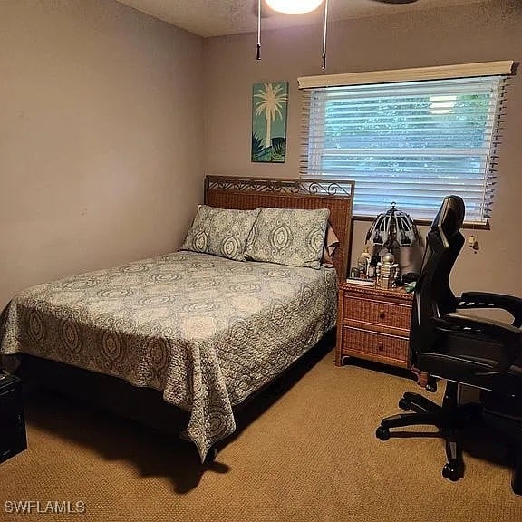 carpeted bedroom with a textured ceiling