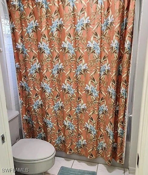 bathroom featuring tile patterned floors and toilet