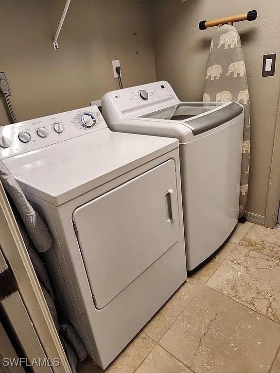 laundry room featuring washing machine and clothes dryer