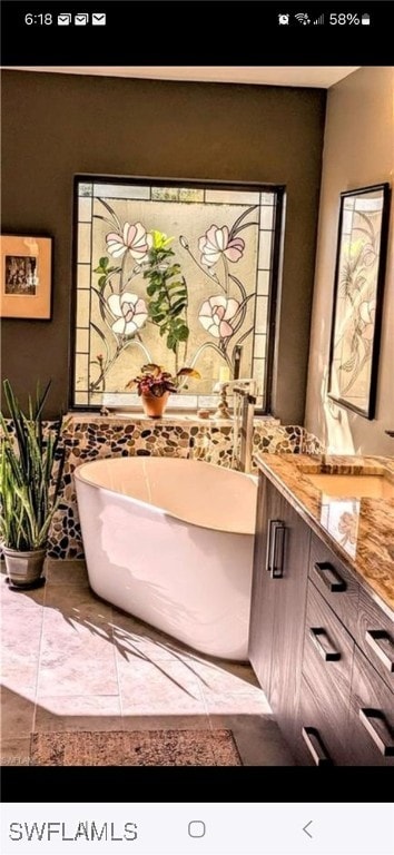 bathroom with a bathtub and vanity