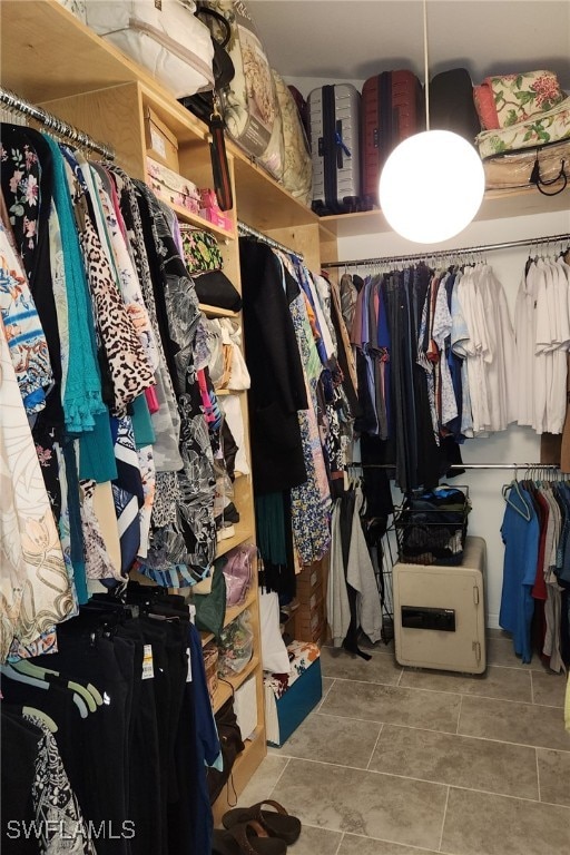 spacious closet with light tile patterned floors